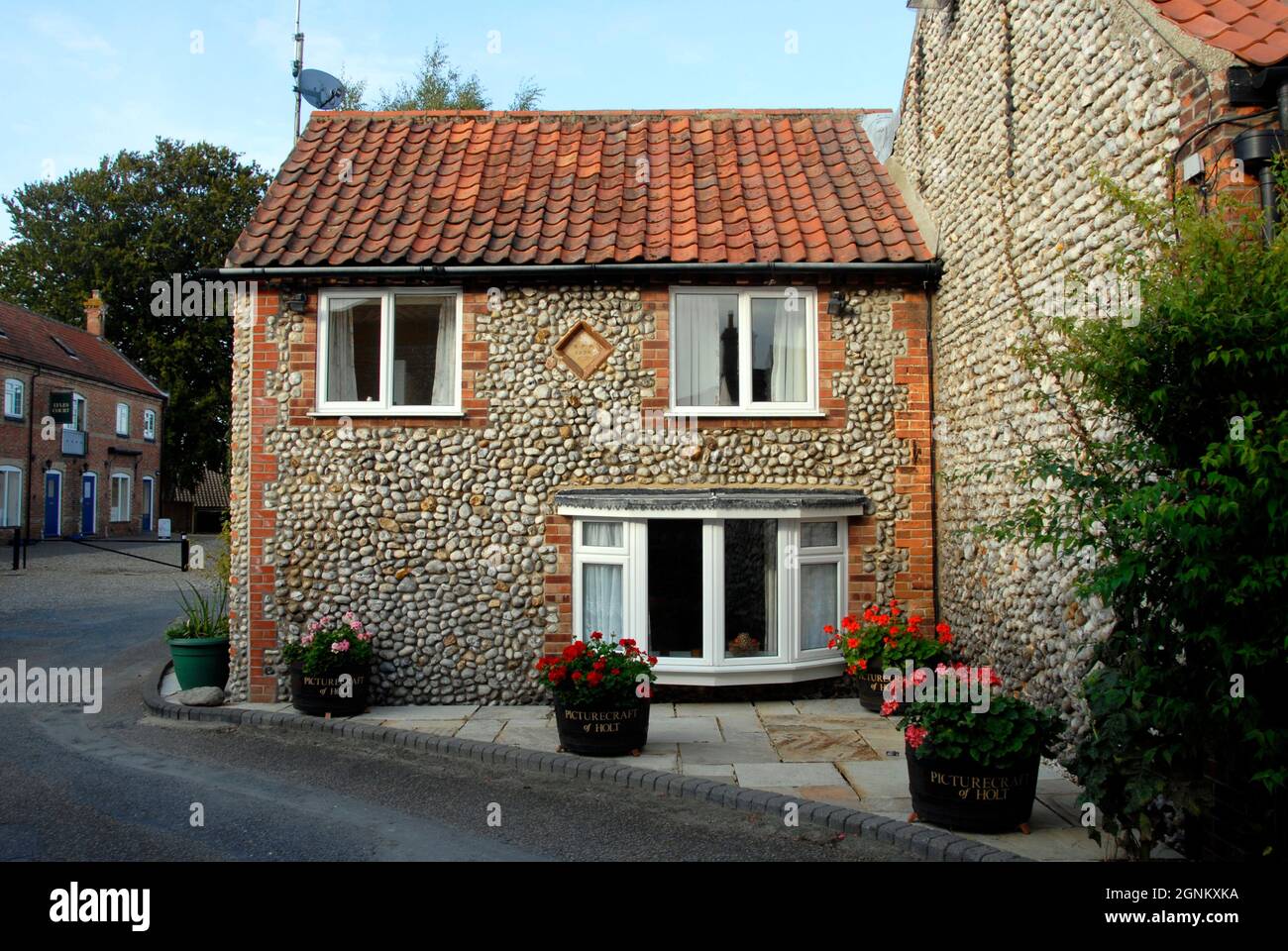 Attractive small house with flint walls and tiled roof in the marked town Holt, Norfolk, England, 2013 Stock Photo