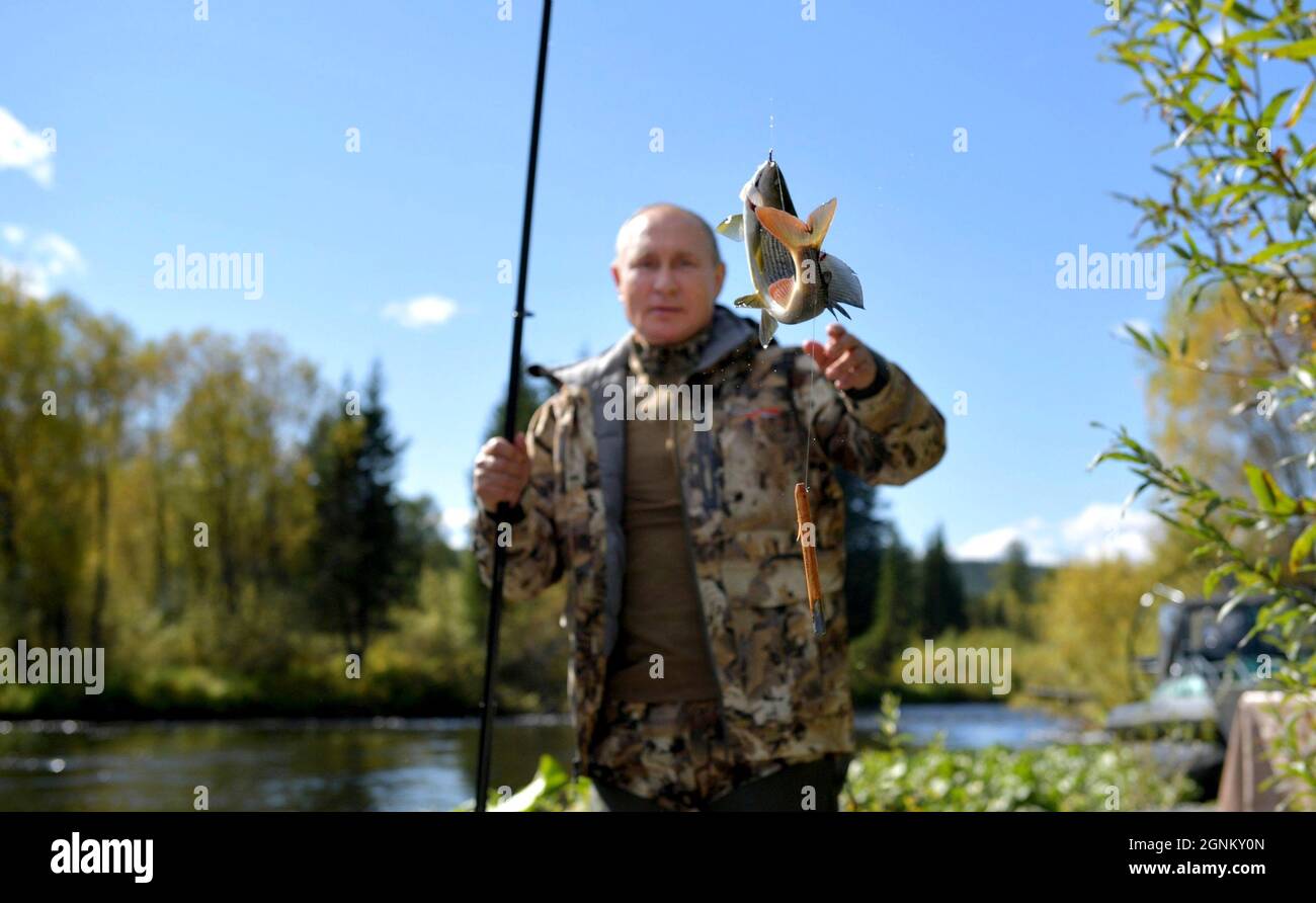 Siberia, Russia. 26th Sep, 2021. Russian President Vladimir Putin pulls in a fish during a short vacation with Defense Minister Sergei Shoigu to fish and hike early September shown in images released September 26, 2021 in the Siberian Federal District of Russia. Putin stopped over during a working visit to the Primorye and the Amur Region of the Russian Far East. Credit: Alexei Druzhinin/Kremlin Pool/Alamy Live News Stock Photo