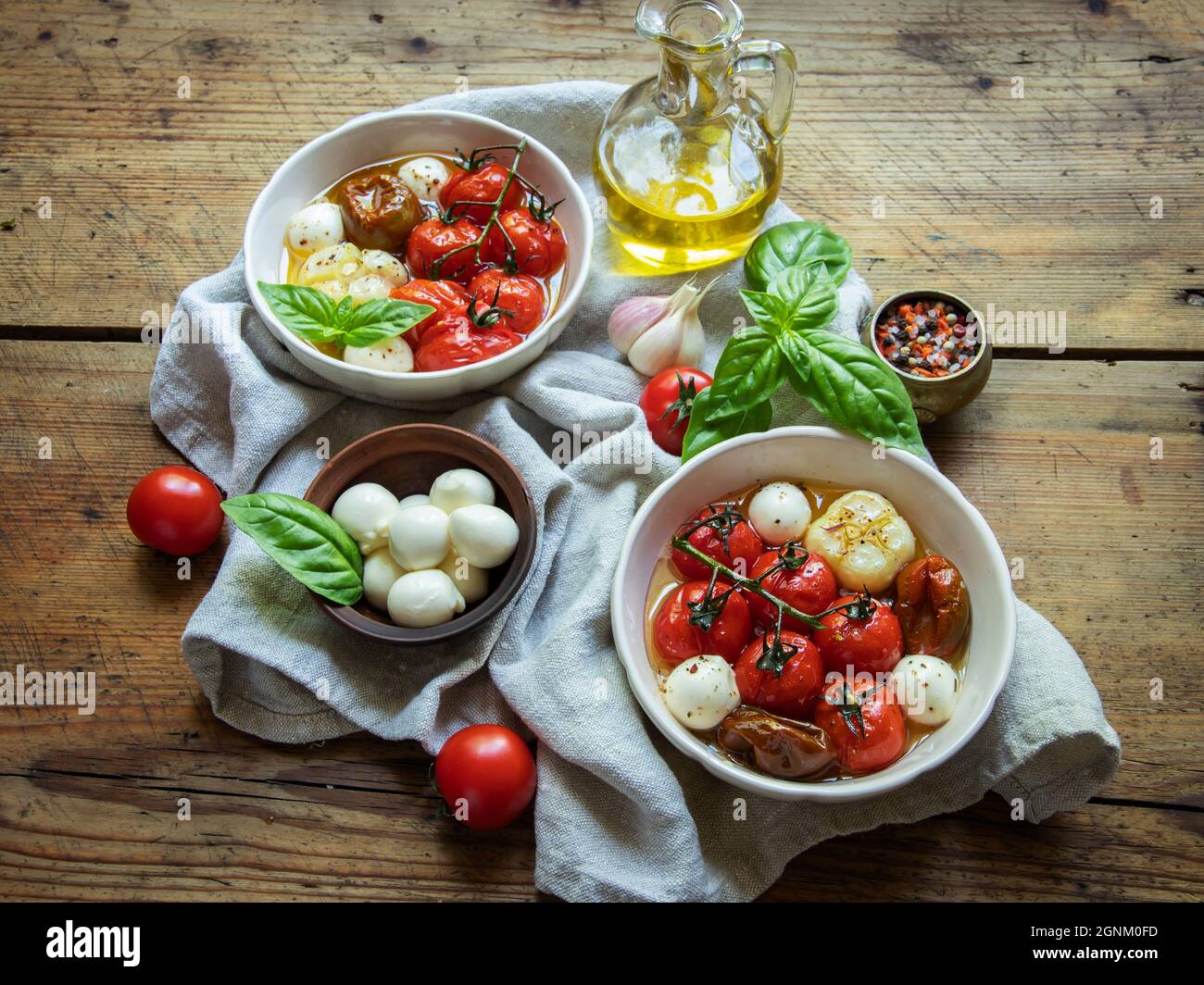 Salad. Baked tomato, basil, garlic with mozzarella cheese, ceramic dishes. cooking, cooked dish Stock Photo