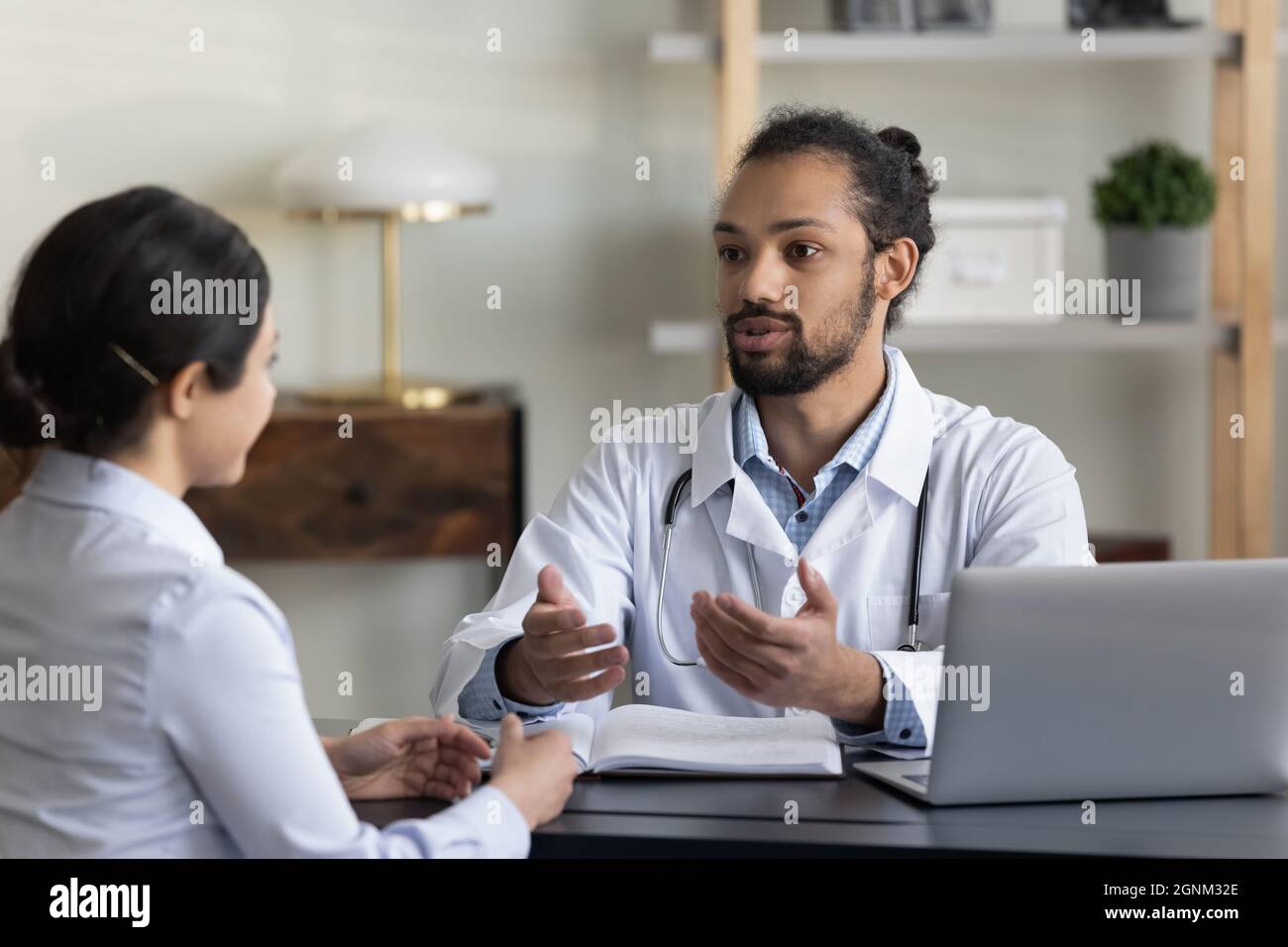 Young male doctor giving consultation, advice, recommendation Stock Photo