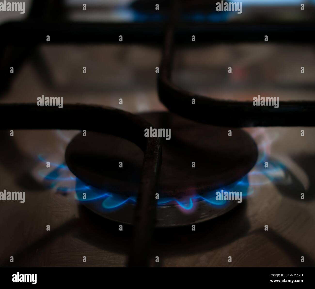 A gas hob in a kitchen with the blue flames of gas fire on. Stock Photo
