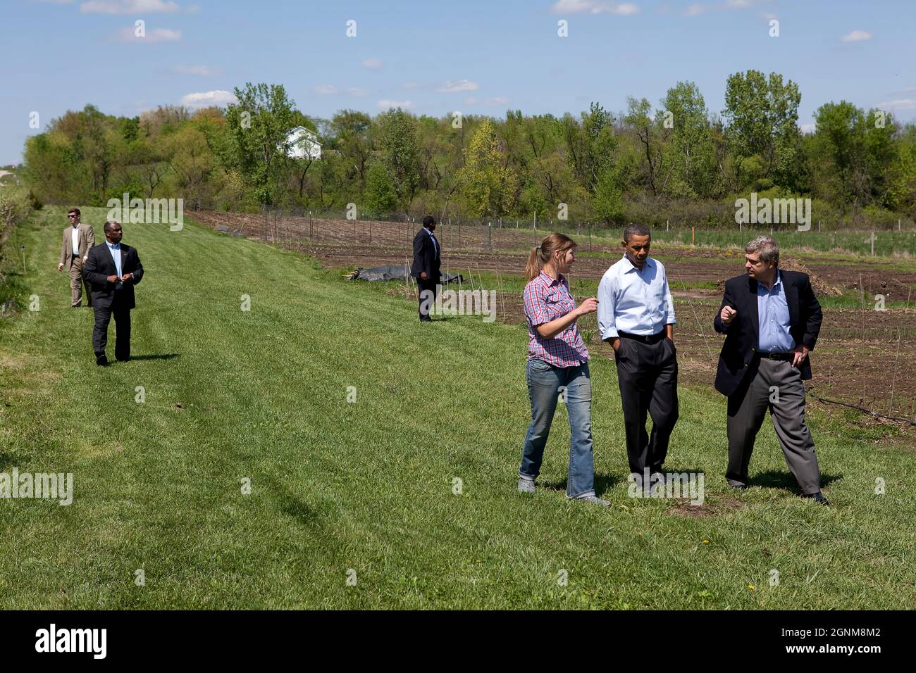 President Barack Obama tours MogoOrganic farm with Agriculture Secretary Tom Vilsack, right, and Morgan Hoenig, left, in Mount Pleasant, Iowa, April 27, 2010. (Official White House Photo by Pete Souza) This official White House photograph is being made available only for publication by news organizations and/or for personal use printing by the subject(s) of the photograph. The photograph may not be manipulated in any way and may not be used in commercial or political materials, advertisements, emails, products, promotions that in any way suggests approval or endorsement of the President, the F Stock Photo