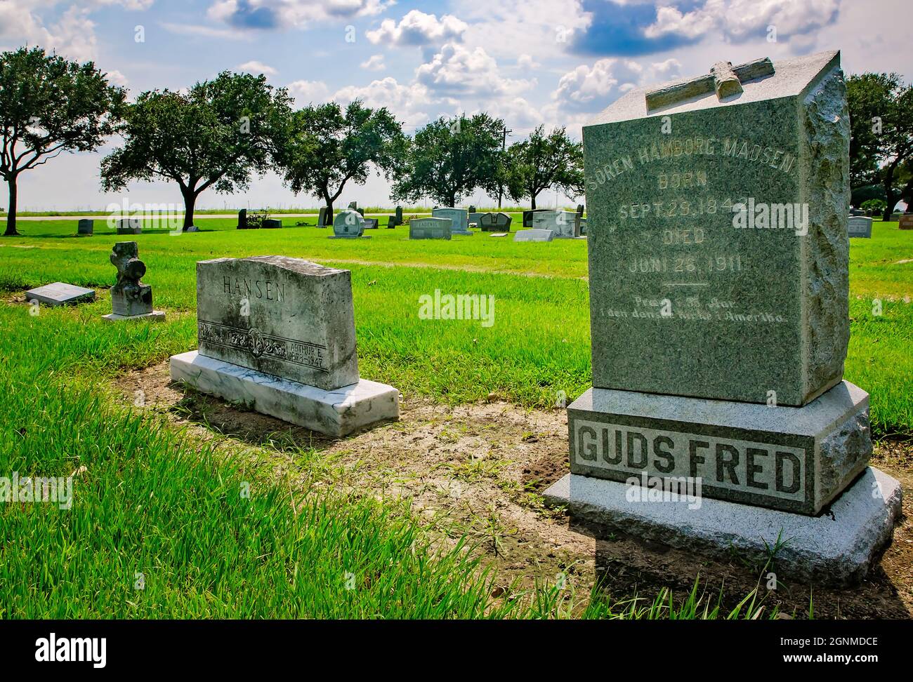 The grave of Danish settler Soren Hamborg Madsen, pastor of Danevang Lutheran Church, is inscribed with the phrase, “Guds Fred” or “God’s Peace.' Stock Photo