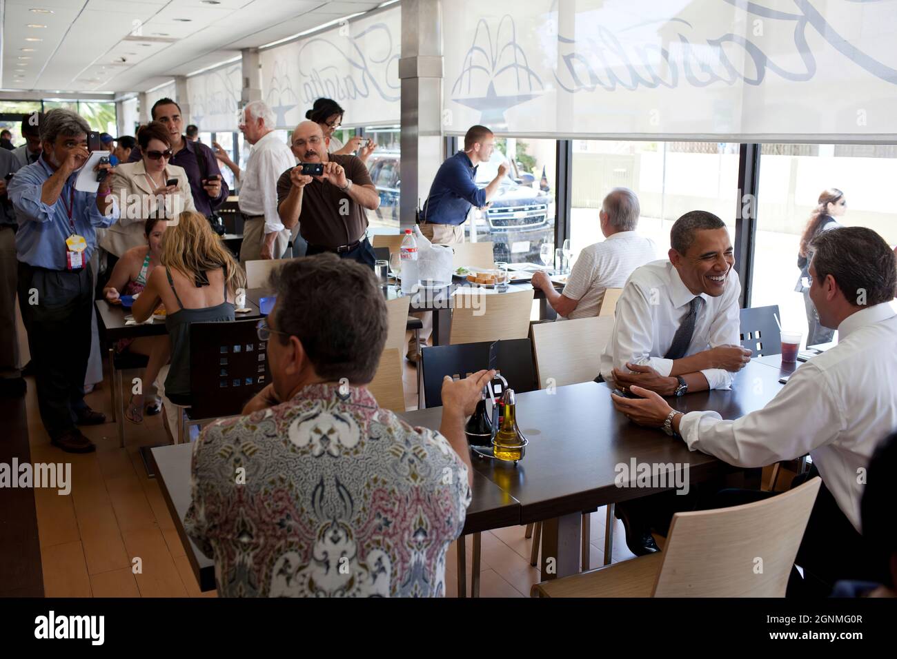 President Barack Obama talks with Puerto Rican Senator Alejandro Garcia Padilla during a lunch stop at Kasalta, a restaurant in the Ocean Park neighborhood of San Juan, Puerto Rico, June 14, 2011. (Official White House Photo by Pete Souza) This official White House photograph is being made available only for publication by news organizations and/or for personal use printing by the subject(s) of the photograph. The photograph may not be manipulated in any way and may not be used in commercial or political materials, advertisements, emails, products, promotions that in any way suggests approval Stock Photo