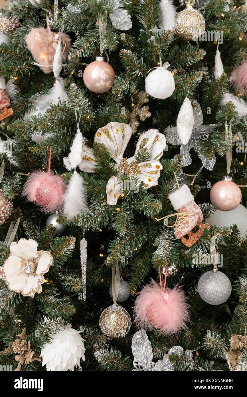 new year and Christmas tree with white and pink toys under the snow Stock Photo