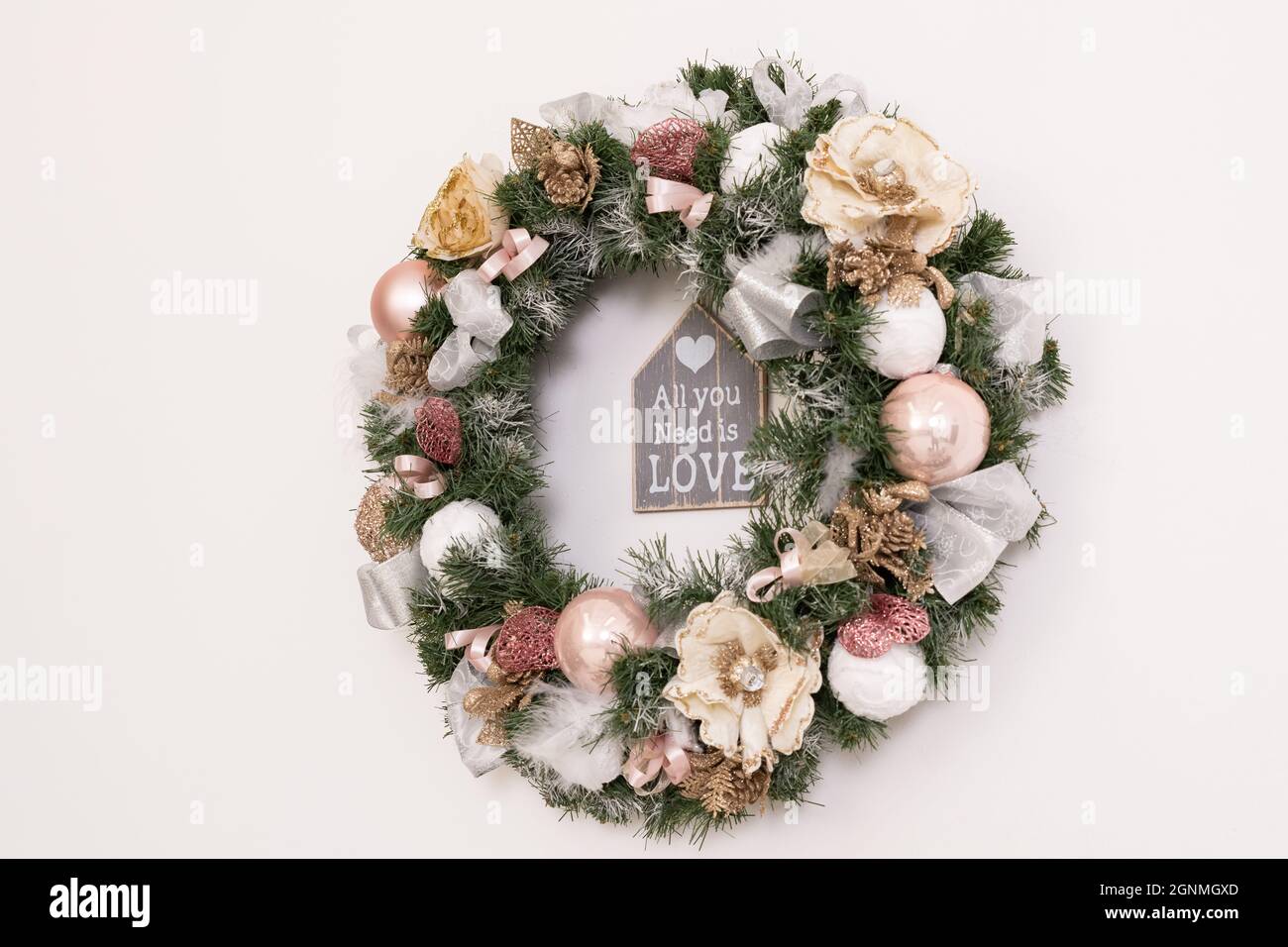 A Christmas wreath hangs on the wall photo at an angle Stock Photo