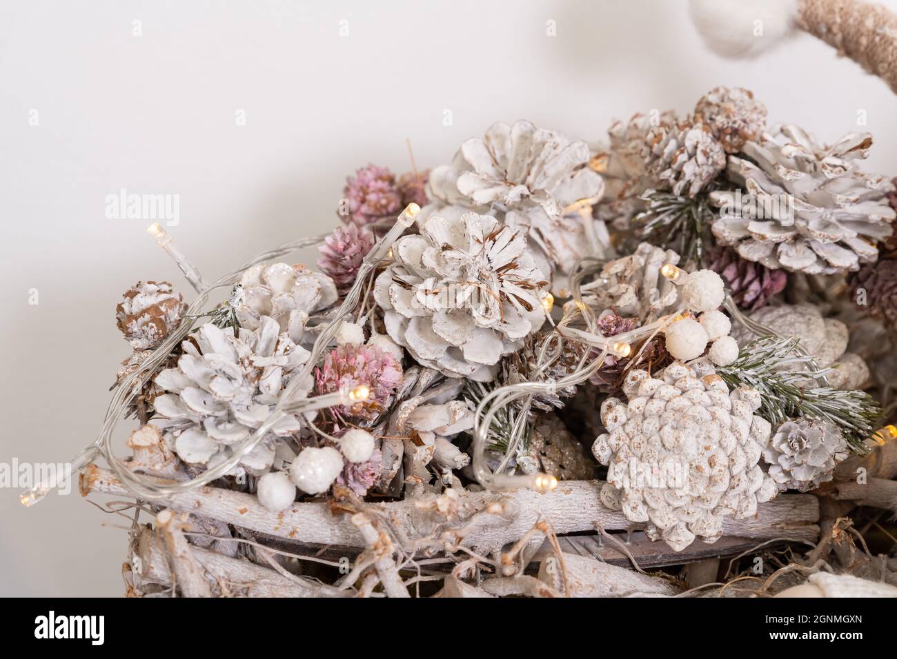 christmas decoration white painted cones in a basket Stock Photo