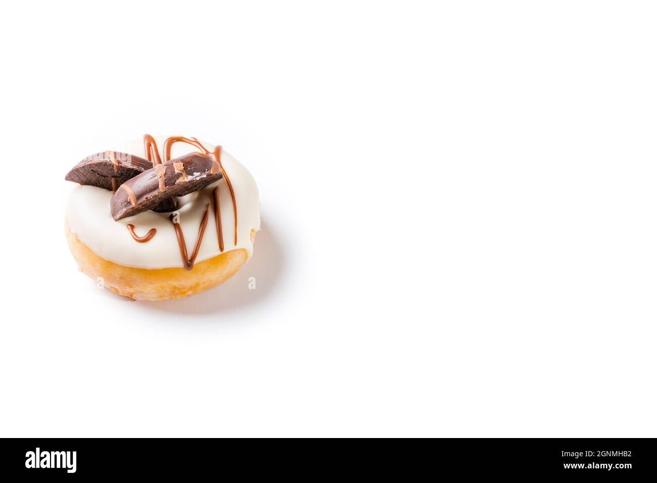 Photograph of a white chocolate donuts with dark chocolate cookies on a white background.The photo is taken in horizontal format and has copy space. Stock Photo