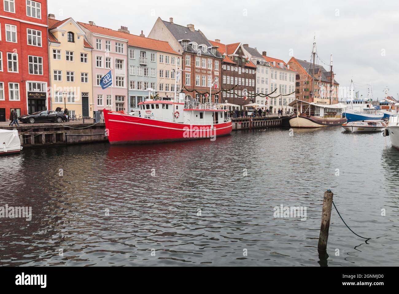 Copenhagen, Denmark - December 10, 2017: Coastal view of Nyhavn or New Harbour, it is a 17th-century waterfront, canal and popular touristic district Stock Photo