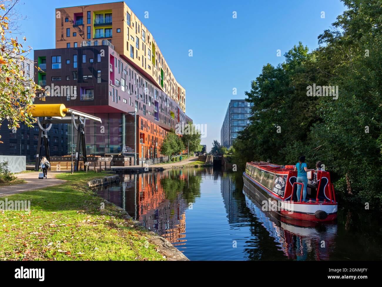 The Chips apartment building, by Will Alsop, a bascule lifting bridge and a narrowboat on the Ashton Canal, New Islington, Ancoats, Manchester, UK Stock Photo