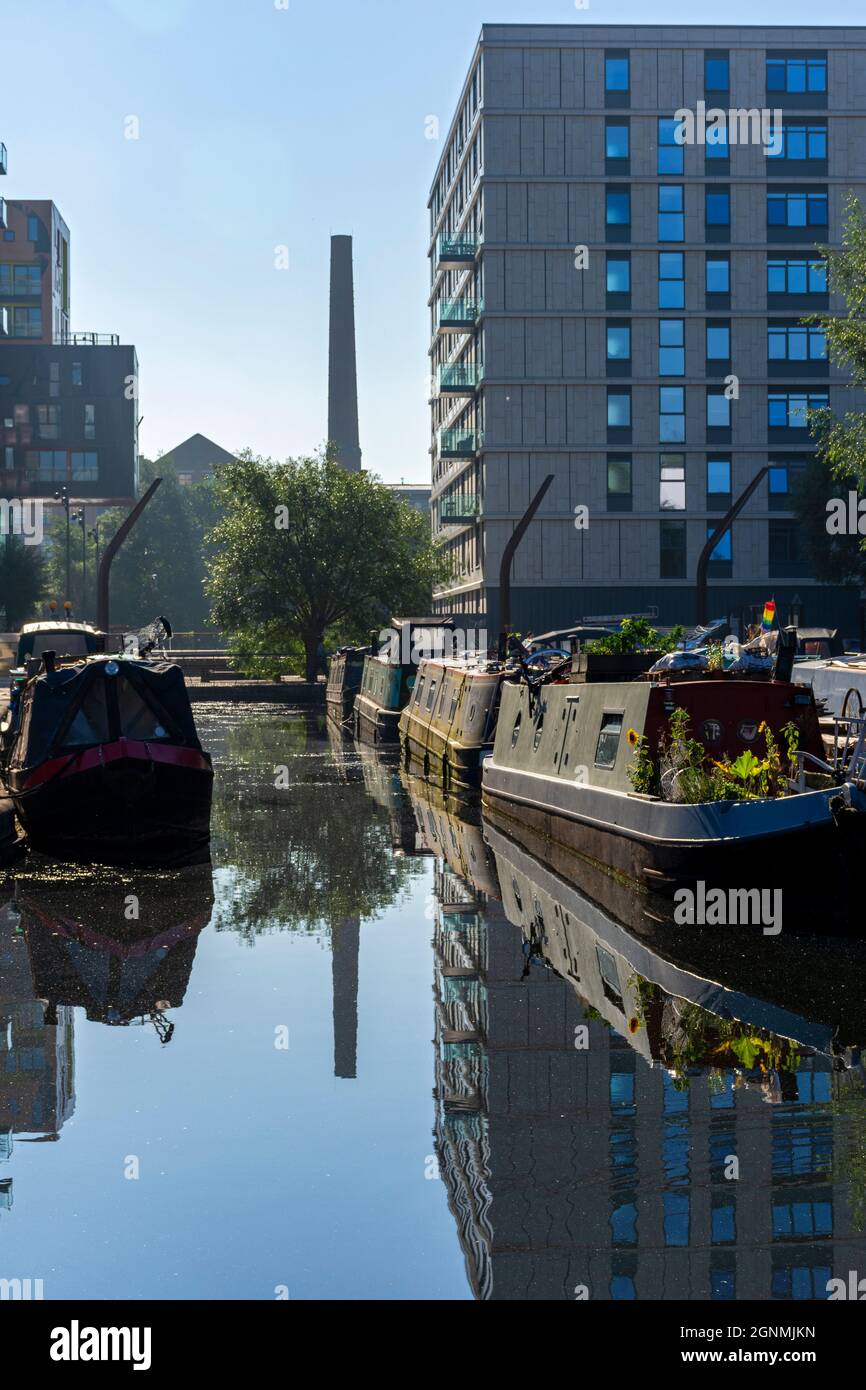 Narrowboats at Cotton Field Park marina, with the One Vesta Street apartment block behind, New Islington, Ancoats, Manchester, England, UK Stock Photo