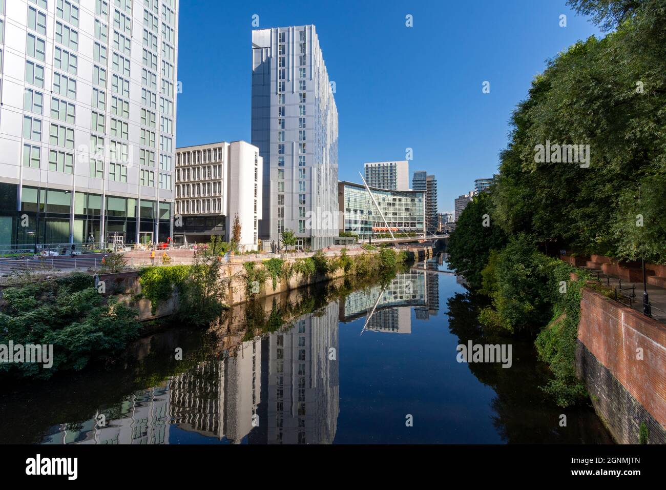 The Trinity Riverside and Riverside apartment blocks, and the Lowry Hotel, reflected in the river Irwell, Salford, Manchester, UK Stock Photo