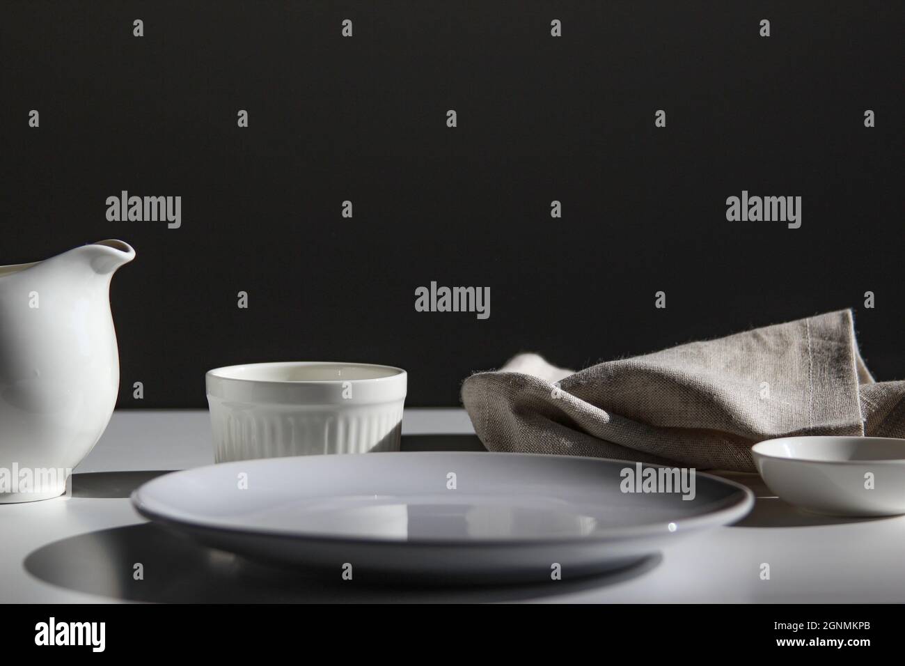 Empty white plate on white stone table, copy space. Stock Photo