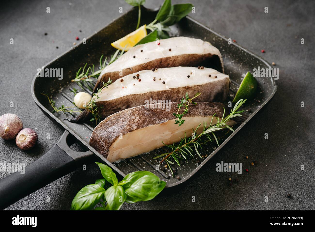 Raw halibut fish steaks prepared for grill in a pan Stock Photo Alamy