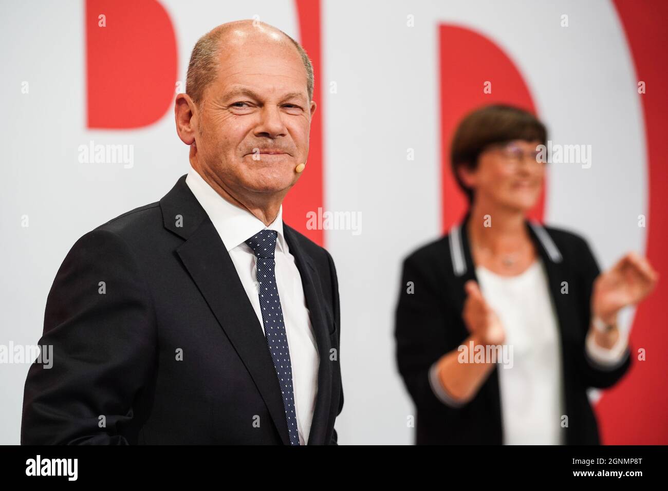 Berlin, Germany. 26th Sep, 2021. Chancellor candidate of Germany's Social Democratic Party (SPD) Olaf Scholz (L) attends a rally at the SPD headquarters in Berlin, Germany, on Sept. 26, 2021. Germany's center-left Social Democratic Party led by the incumbent Vice Chancellor and Finance Minister Olaf Scholz, won about 26 percent of the vote in the federal election on Sunday, according to the preliminary exit poll released by German media ZDF. Credit: Stefan Zeitz/Xinhua/Alamy Live News Stock Photo