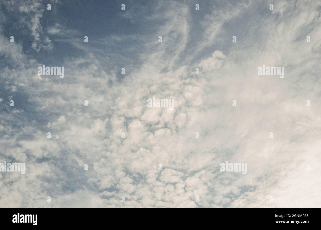 Beautiful curly clouds with dark sky background Stock Photo - Alamy