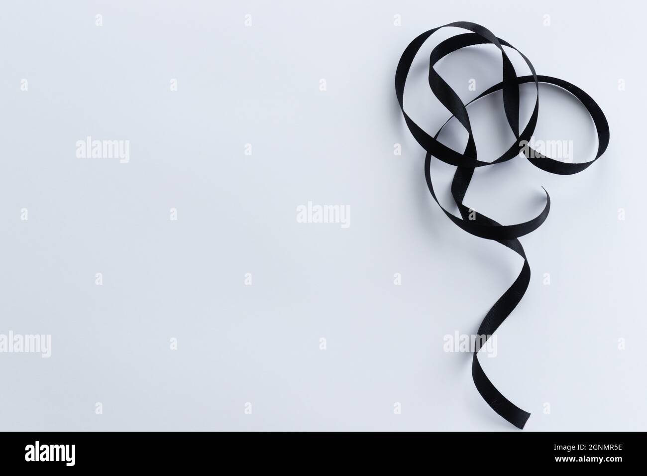 Black ribbon on a white background with a copy space. Stock Photo