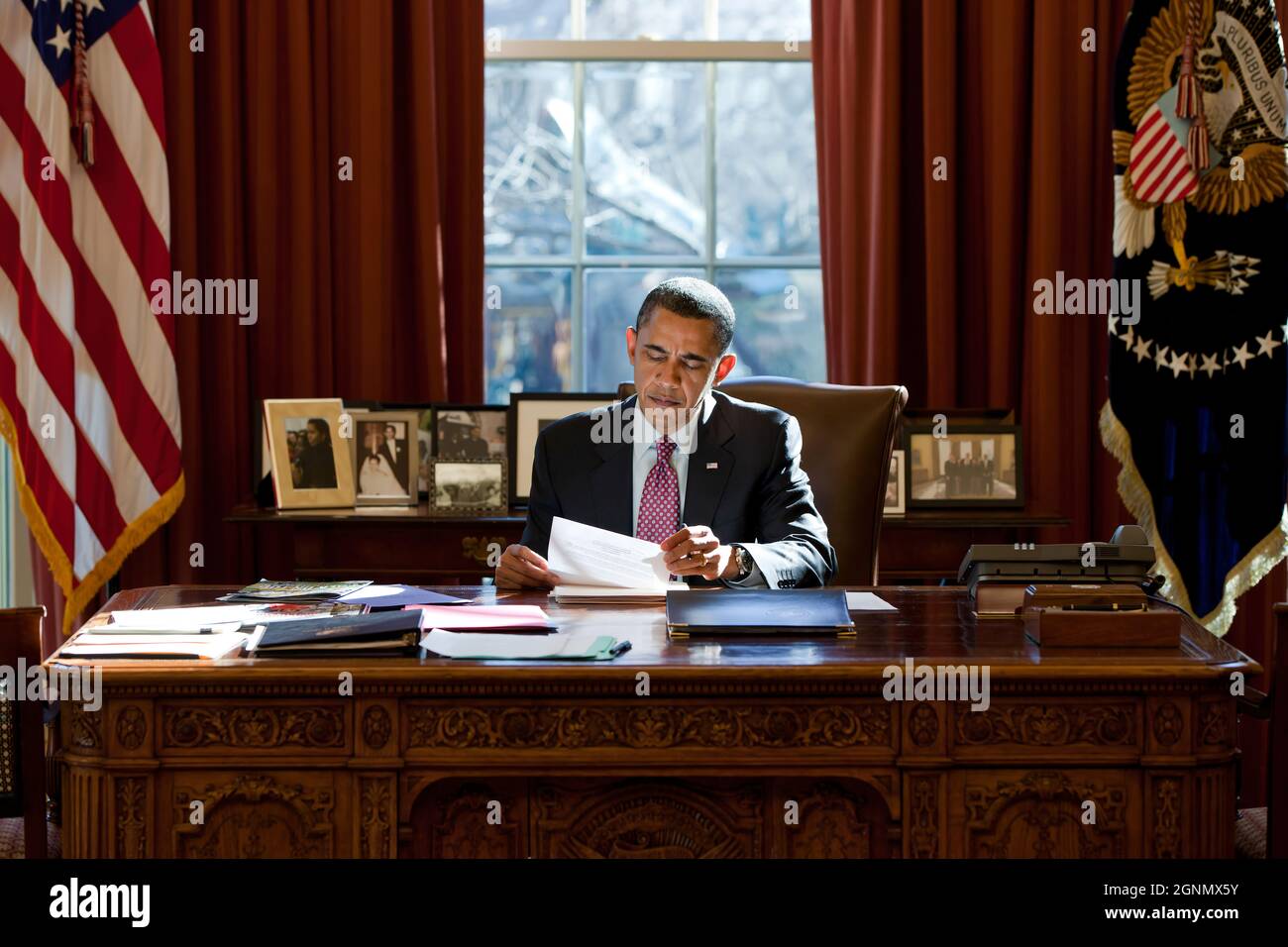 President Barack Obama reviews his prepared remarks on Egypt at the Resolute Desk in the Oval Office, Feb. 11, 2011. (Official White House Photo by Pete Souza) This official White House photograph is being made available only for publication by news organizations and/or for personal use printing by the subject(s) of the photograph. The photograph may not be manipulated in any way and may not be used in commercial or political materials, advertisements, emails, products, promotions that in any way suggests approval or endorsement of the President, the First Family, or the White House. Stock Photo