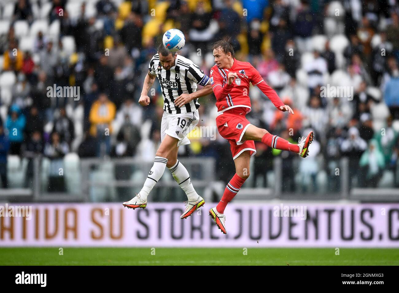 Turin, Italy. 26 September 2021. Leonardo Bonucci (L) of Juventus FC competes for a header with Mikkel Damsgaard of UC Sampdoria during the Serie A football match between Juventus FC and UC Sampdoria. Credit: Nicolò Campo/Alamy Live News Stock Photo