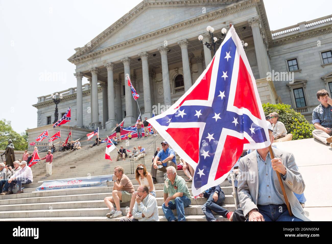 Confederate supporters gather on the steps of the South Carolina capital building waving rebel flags to mark Confederate Memorial Day May 7, 2016 in Columbia, South Carolina. The events marking southern Confederate heritage come nearly a year after the removal of the confederate flag from the capitol following the murder of nine people at the historic black Mother Emanuel AME Church. Stock Photo