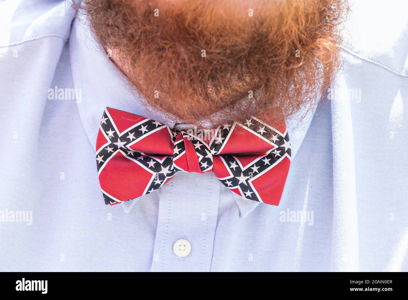A confederate supporter wears a rebel flag bow tie during a memorial ceremony at Elmwood Cemetery to mark Confederate Memorial Day May 7, 2016 in Columbia, South Carolina. The events marking southern Confederate heritage come nearly a year after the removal of the confederate flag from the capitol following the murder of nine people at the historic black Mother Emanuel AME Church. Stock Photo