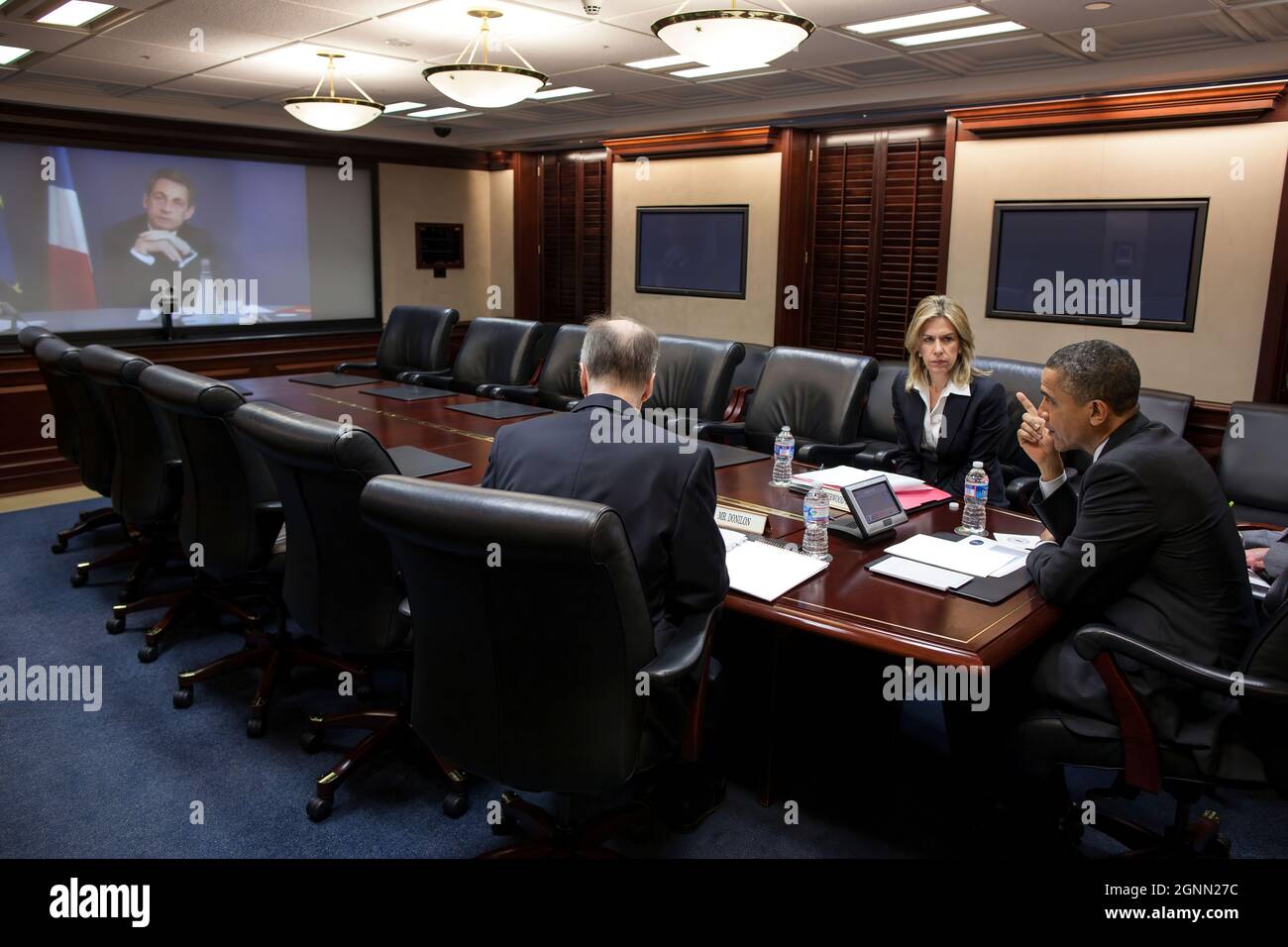 President Barack Obama participates in a video teleconference with President Nicolas Sarkozy of France, in the Situation Room of the White House, April 12, 2012. National Security Advisor Tom Donilon and Liz Sherwood-Randall, Special Assistant to the President and Senior Director for European Affairs, are seated with the President. (Official White House Photo by Pete Souza) This official White House photograph is being made available only for publication by news organizations and/or for personal use printing by the subject(s) of the photograph. The photograph may not be manipulated in any way Stock Photo