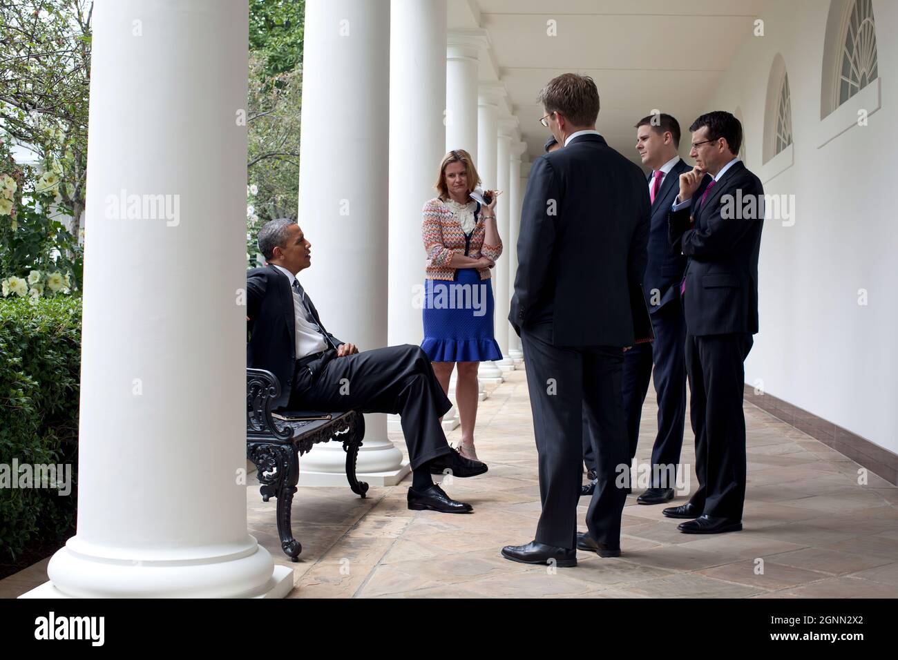 President Barack Obama talks with staff along the Colonnade of the ...