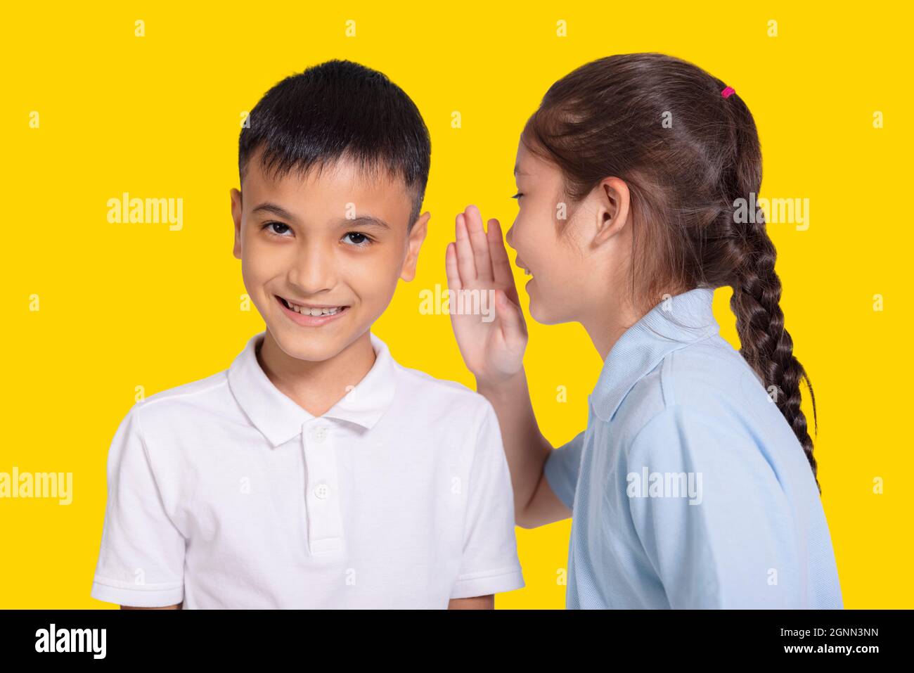 Happy student girl and boy whispers. Stock Photo