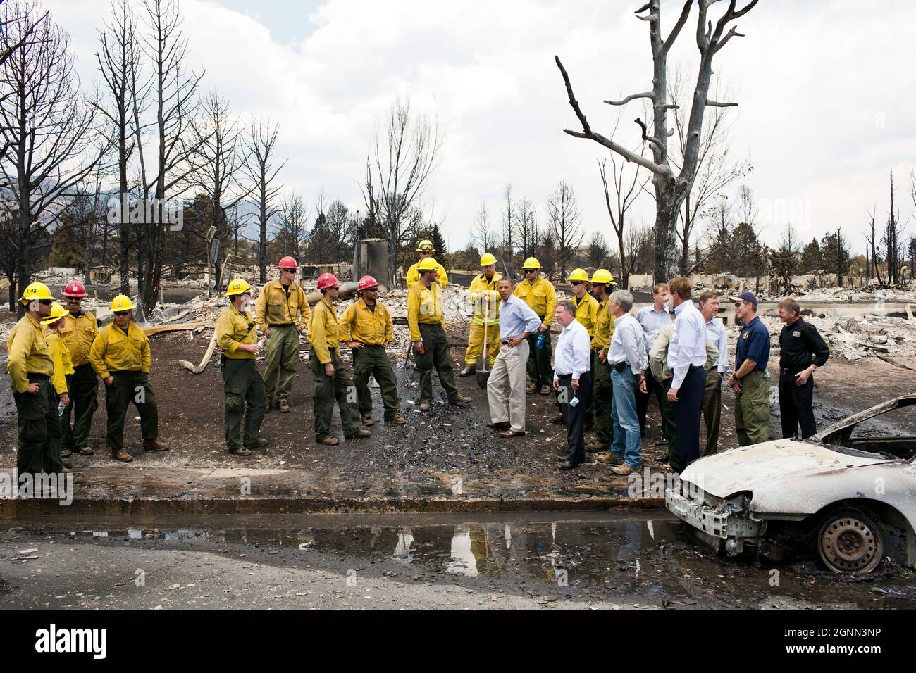 President Barack Obama views fire damage with firefighters and elected officials in Colorado Springs, Colo., June 29, 2012. (Official White House Photo by Pete Souza) This official White House photograph is being made available only for publication by news organizations and/or for personal use printing by the subject(s) of the photograph. The photograph may not be manipulated in any way and may not be used in commercial or political materials, advertisements, emails, products, promotions that in any way suggests approval or endorsement of the President, the First Family, or the White House. Stock Photo