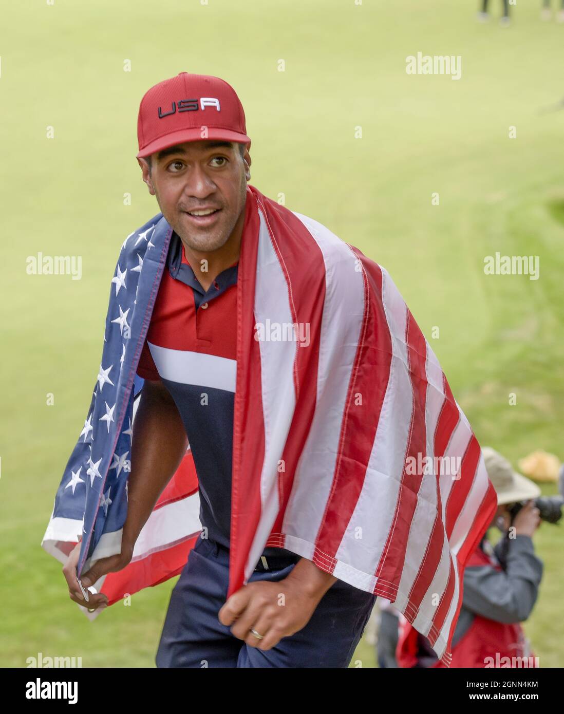 Kohler, United States. 26th Sep, 2021. Draped in an American Flag Team USA's Tony Finau heads up the stairs from the 18th green toward the clubs house after celebrating Team USA's win of the 43rd Ryder Cup at Whistling Straits on Sunday, September 26, 2021 in Kohler, Wisconsin. Photo by Mark Black/UPI Credit: UPI/Alamy Live News Stock Photo