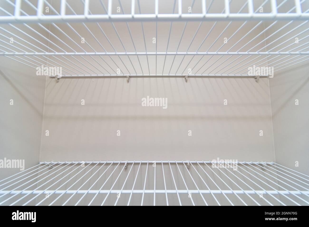 Empty wire shelving storage in an empty closet Stock Photo