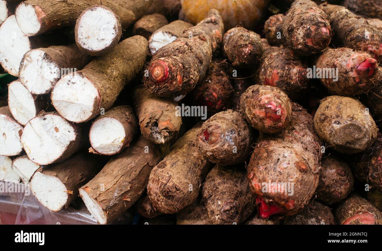 sale of cassava in fruit and vegetable market, display of cassava in public market counter Stock Photo
