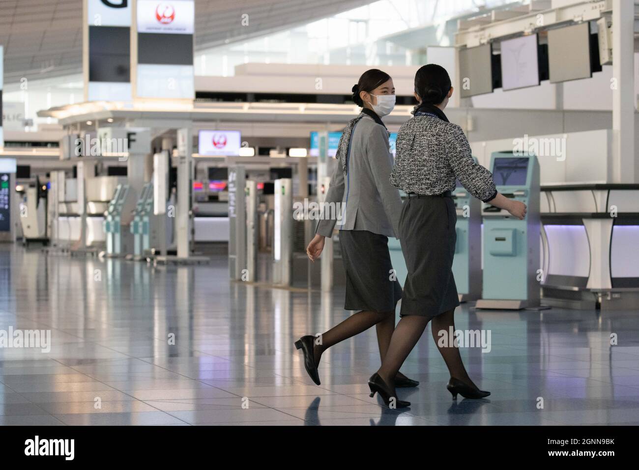 JAL employees walk through Haneda Airport Terminal 3 Checkin area on