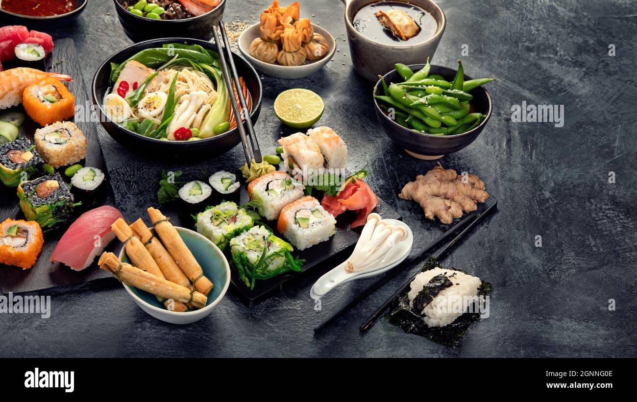 Japanese dishes and snacks on gray background. Traditional food concept. Copy space Stock Photo