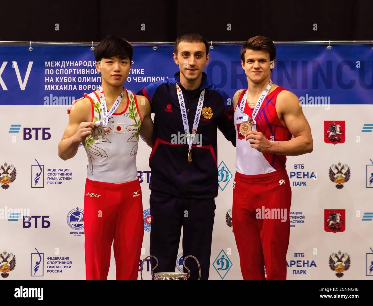 Dmitry Lankin (R), Artur Davtyan (C) and Miwa Teppi (L) seen posing with their medals during the event. The XXV International Gymnastics Tournament for the Cup of the Olympic Champion Mikhail Voronin was held at the Olimpiyskiy sports complex. Stock Photo