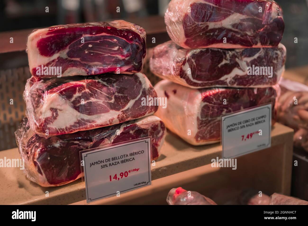 Carved pieces of Spanish serrano iberico ham for sale at a local butcher shop in the old town or Casco Viejo in Pamplona Spain Stock Photo