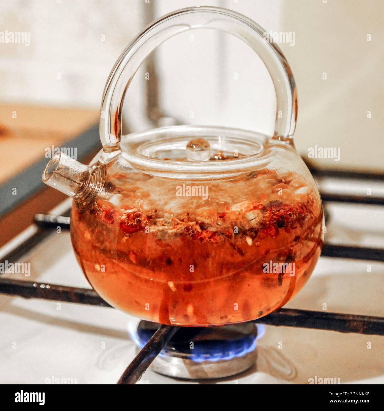 https://c8.alamy.com/comp/2GNNKKF/red-tea-drink-is-boiled-in-a-glass-kettle-on-a-gas-stove-close-up-2GNNKKF.jpg
