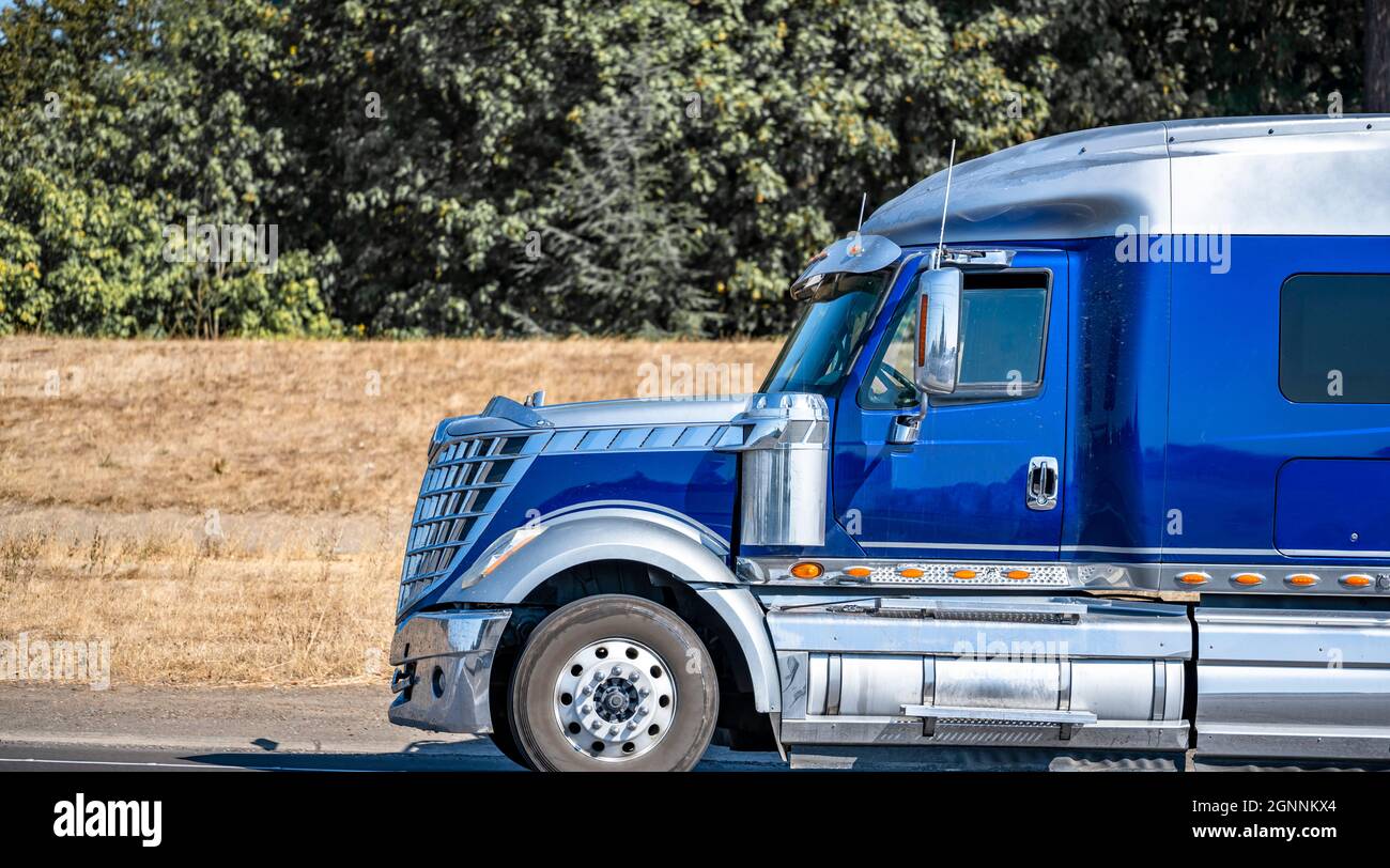 Powerful classic blue and silver big rig semi truck tractor with truck  driver rest compartment and lot of chrome and aluminum accessories driving  on t Stock Photo - Alamy