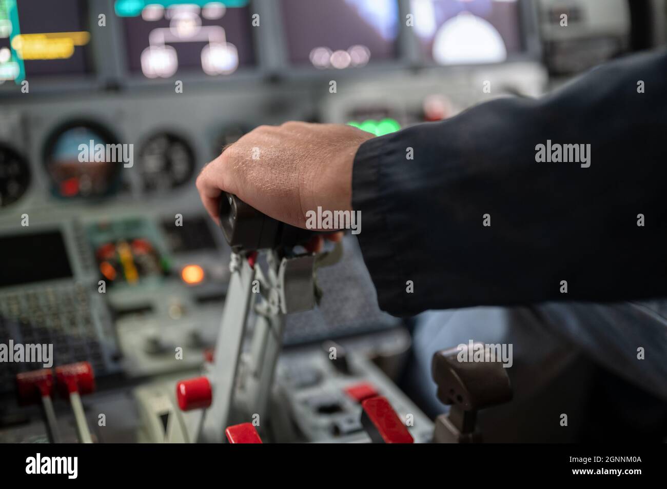 Engine thrust levers. The pilot's hand holds the levers. Stock Photo