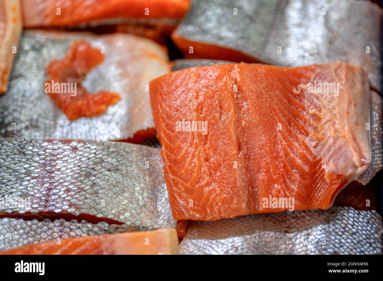 Many pieces of salmon and trout fillet, close-up photo. Stock Photo