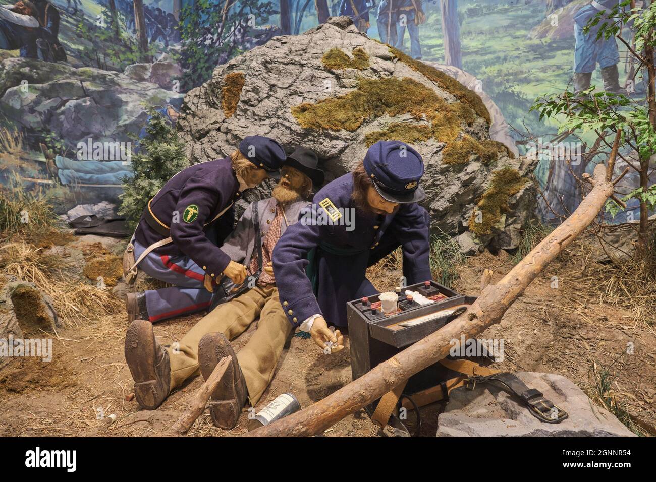 Soldier medics applying field dressing to a wounded man. At the