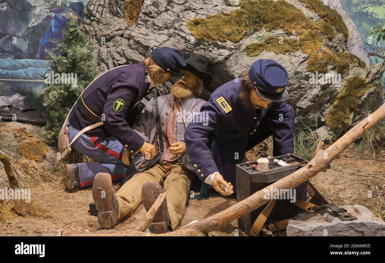 Soldier medics applying field dressing to a wounded man. At the