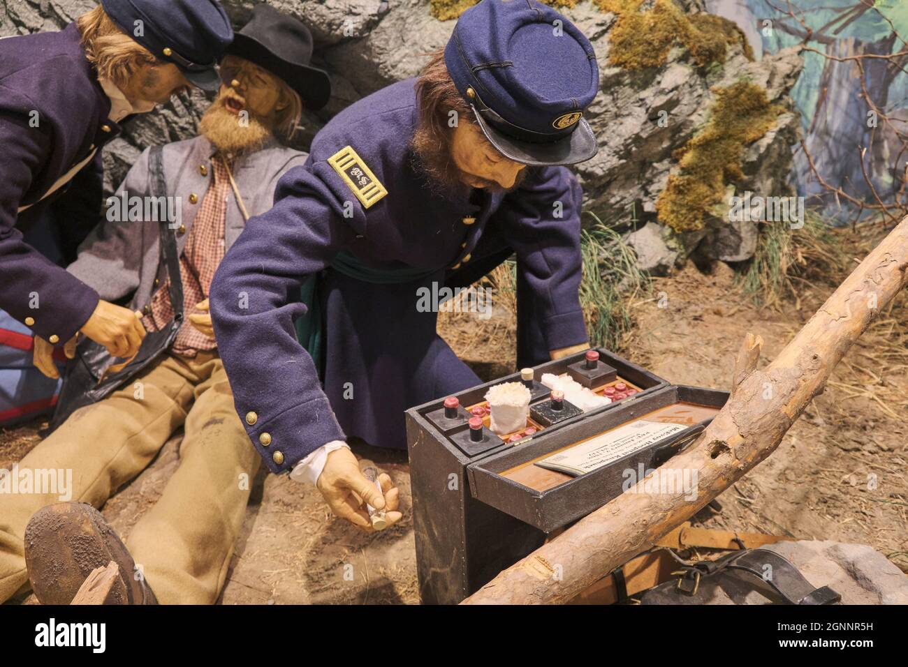 Soldier medics applying field dressing to a wounded man. At the
