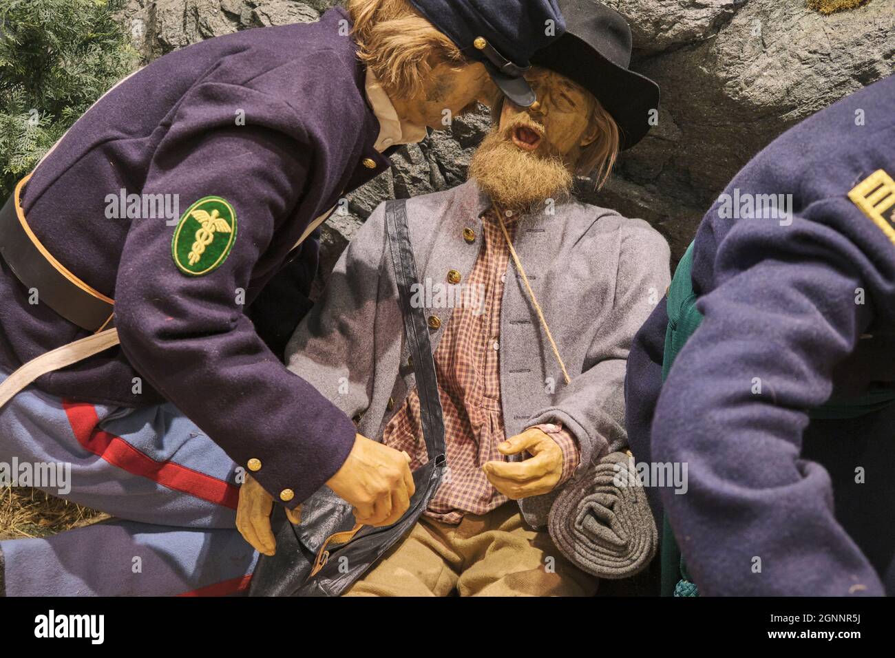 Soldier medics applying field dressing to a wounded man. At the