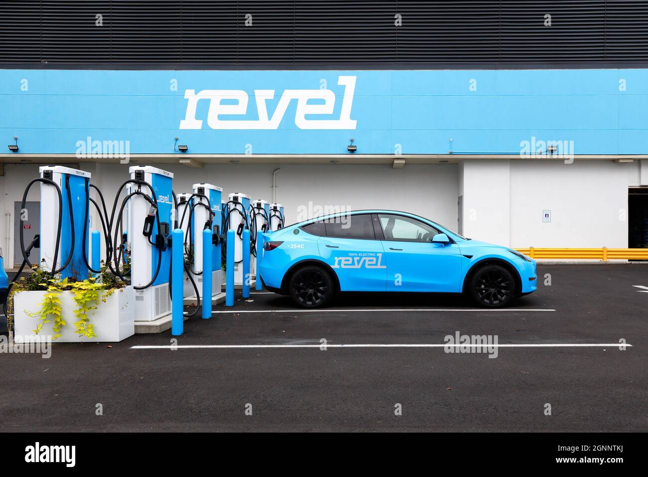Electric chargers at Revel's superhub in Brooklyn. The EV charging station is equipped with Tritrium 75kWh ... [see additional info for full caption]. Stock Photo