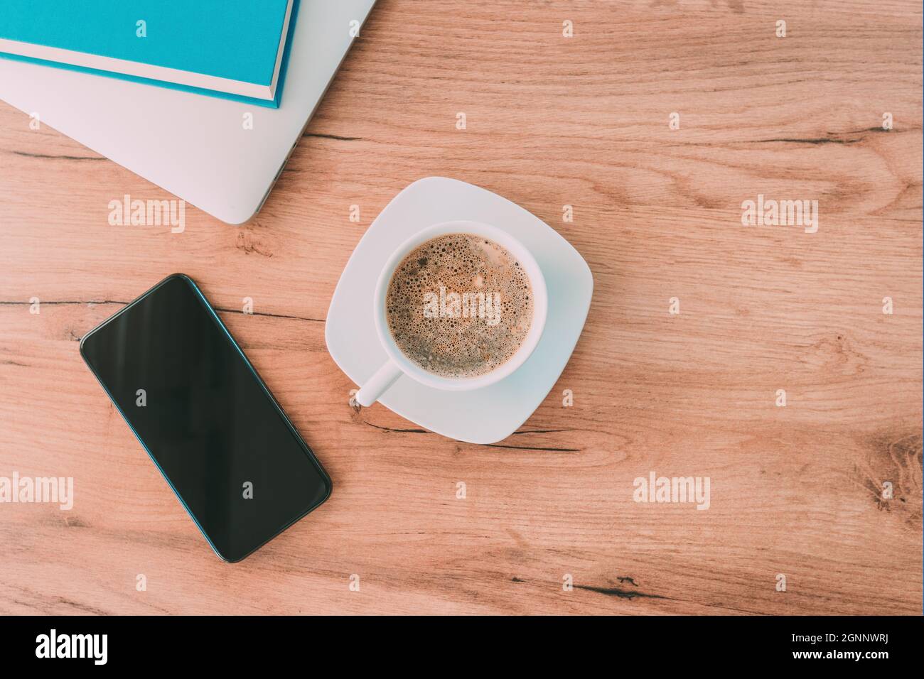 Morning coffee before starting the freelance job, coffee cup on home office desk, top view Stock Photo