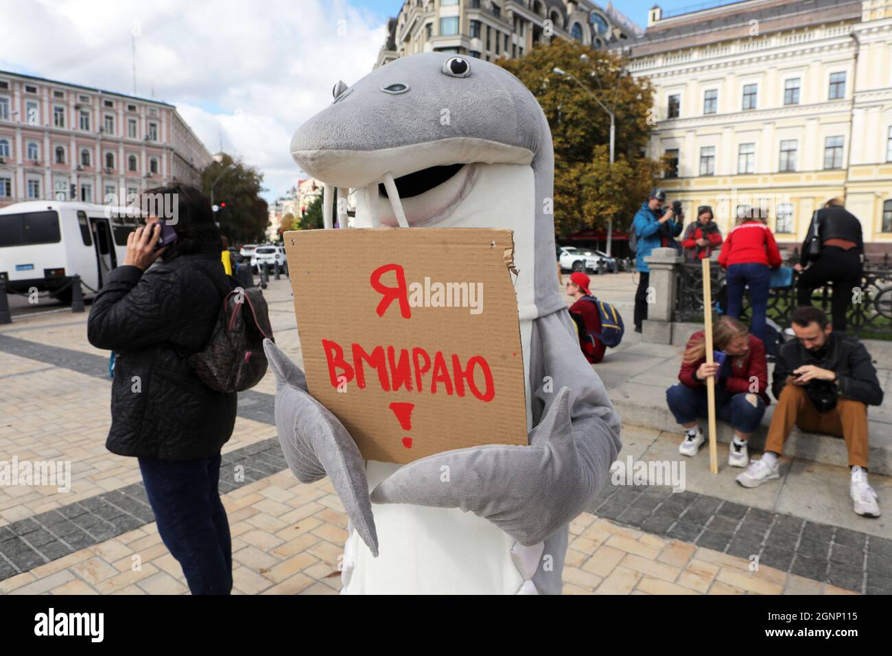 KYIV, UKRAINE - SEPTEMBER 26, 2021 - An environmental activist holds the 'I'm Dying' placard in Mykhailivska Square during the march urging to address Stock Photo