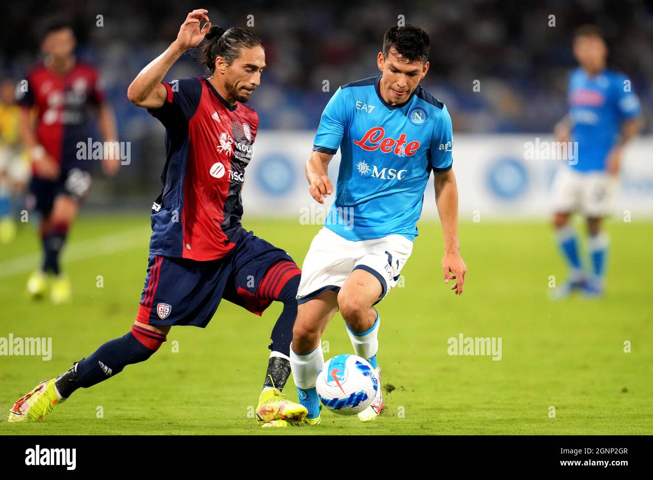 NAPLES, ITALY - SEPTEMBER 26: Hirving Lozano of SSC Napoli competes for the ball with Martin Caceres of Cagliari Calcio ,during the Serie A match between SSC Napoli and Cagliari Calcio at Stadio Diego Armando Maradona on September 26, 2021 in Naples, Italy. (Photo by MB Media) Stock Photo