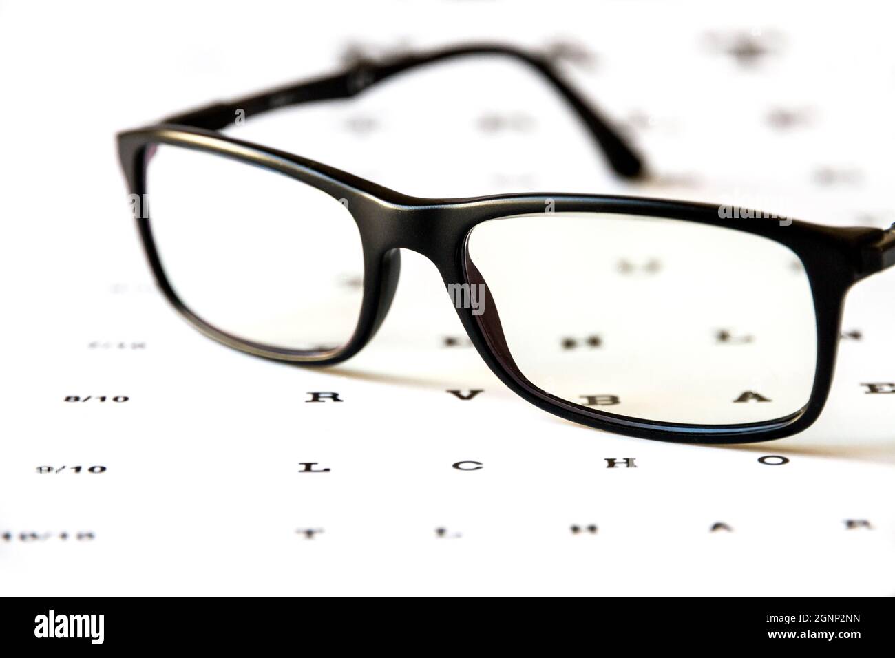 Glasses on eye chart. Optical device background Stock Photo Alamy