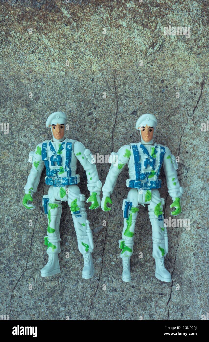 Plastic models of two men in action gear standing as if preparing to face enemy Stock Photo